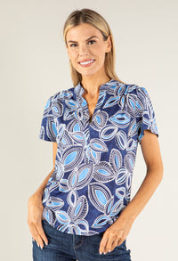 woman wearing navy top on plain background 