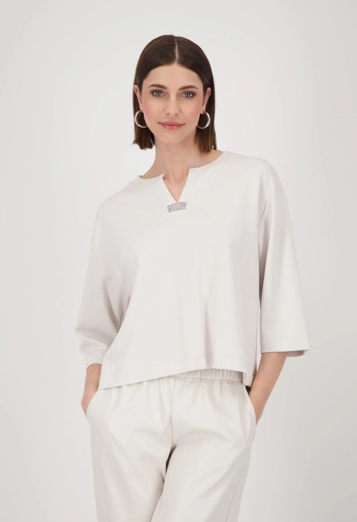 Woman wearing a white outfit with a plain background