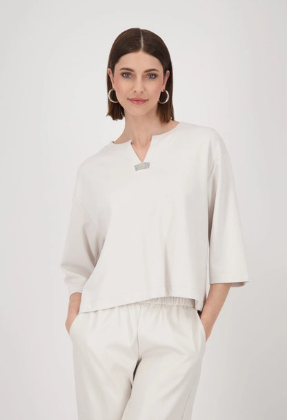 Woman wearing a white outfit with a plain background