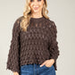woman wearing a chocolate brown scalloped knit jumper