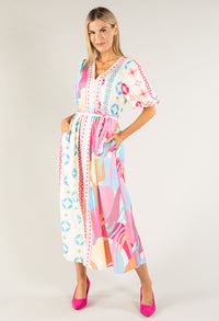 Woman wearing a colorful patterned dress on a white background