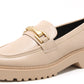Beige loafer shoe with gold buckle on a white background