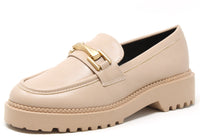 Beige loafer shoe with gold buckle on a white background
