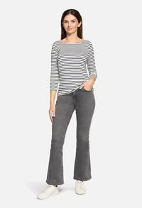 Woman wearing a striped top with 3/4 length sleeves and straight hemline