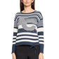 Woman wearing a blue and white striped sweater with a graphic design on a white background