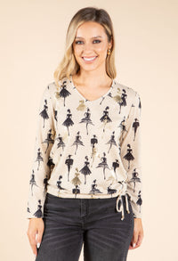 model wearing beige and black top on beige background