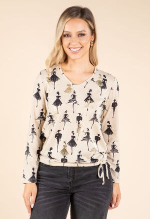model wearing beige and black top on beige background
