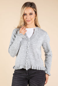 Model wearing grey cardigan on beige background