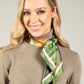 woman wearing a knit top and a green neck scarf