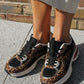 Leopard print sneakers worn on a concrete surface with a brick wall in the background