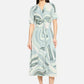 Woman wearing a patterned dress on a white background