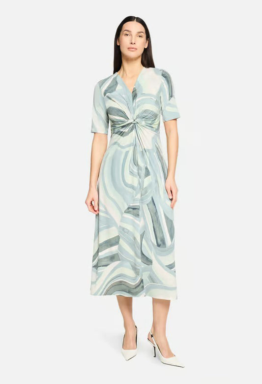 Woman wearing a patterned dress on a white background