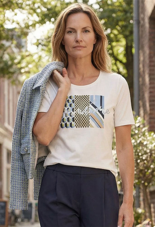 Woman wearing a white t-shirt with a graphic design outdoors