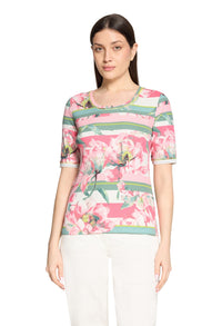 Woman wearing a floral print top on a white background