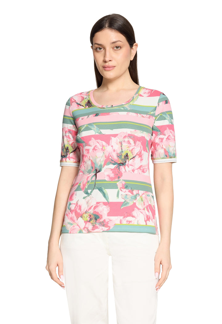 Woman wearing a floral print top on a white background