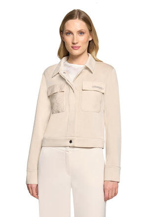 Woman wearing a beige jacket on a white background