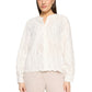 Woman wearing a white lace blouse and beige pants on a white background