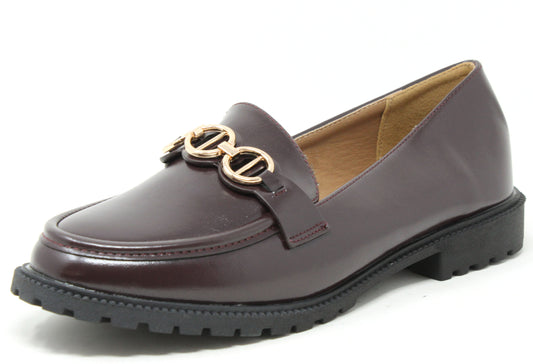 Black loafer shoe with gold chain detail on a white background