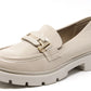 Beige loafer shoe with gold buckle on a white background