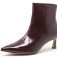 Burgundy leather ankle boot on a white background