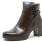 Brown leather ankle boot with a buckle on a white background