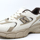White and brown athletic shoe on a white background