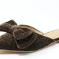 Brown velvet pointed flat shoe on a while background. With bow detail 