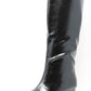 Black knee-high boot on a white background