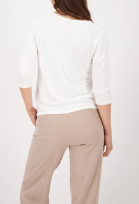 Top with decorative emblem