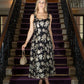 Woman in a floral dress standing on a staircase with purple steps
