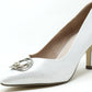 White high-heeled shoe with a decorative buckle on a white background