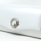 White clutch bag with silver clasp on a white background