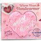 Pink heart-shaped handwarmer with 'Warm Heart' text on a matching packaging box.