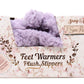 Pack of feet warmers and plush slippers with floral design and text on packaging