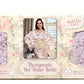Packaging of a therapeutic hot water bottle with floral design and woman in robe photo.