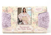 Packaging of a therapeutic hot water bottle with floral design and woman in robe photo.