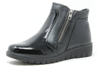 Black patent leather ankle boot with a zipper on a white background