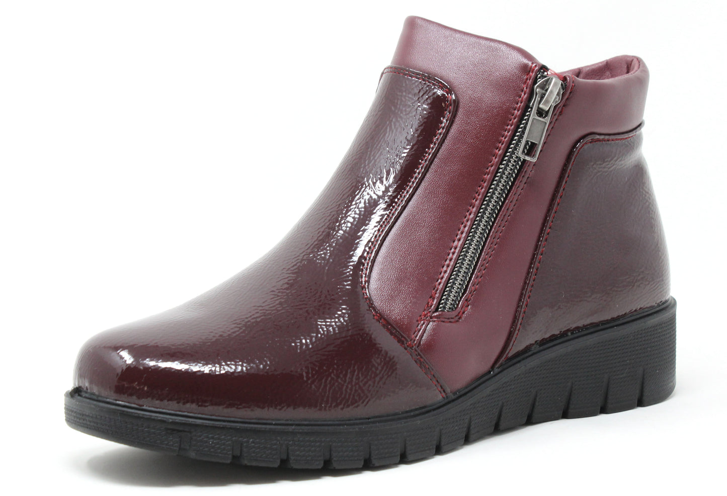 Burgundy patent leather ankle boot with a zipper on a white background