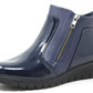 navy patent leather ankle boot with a zipper on a white background