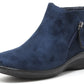 navy faux suede boot with zip detail on a white background