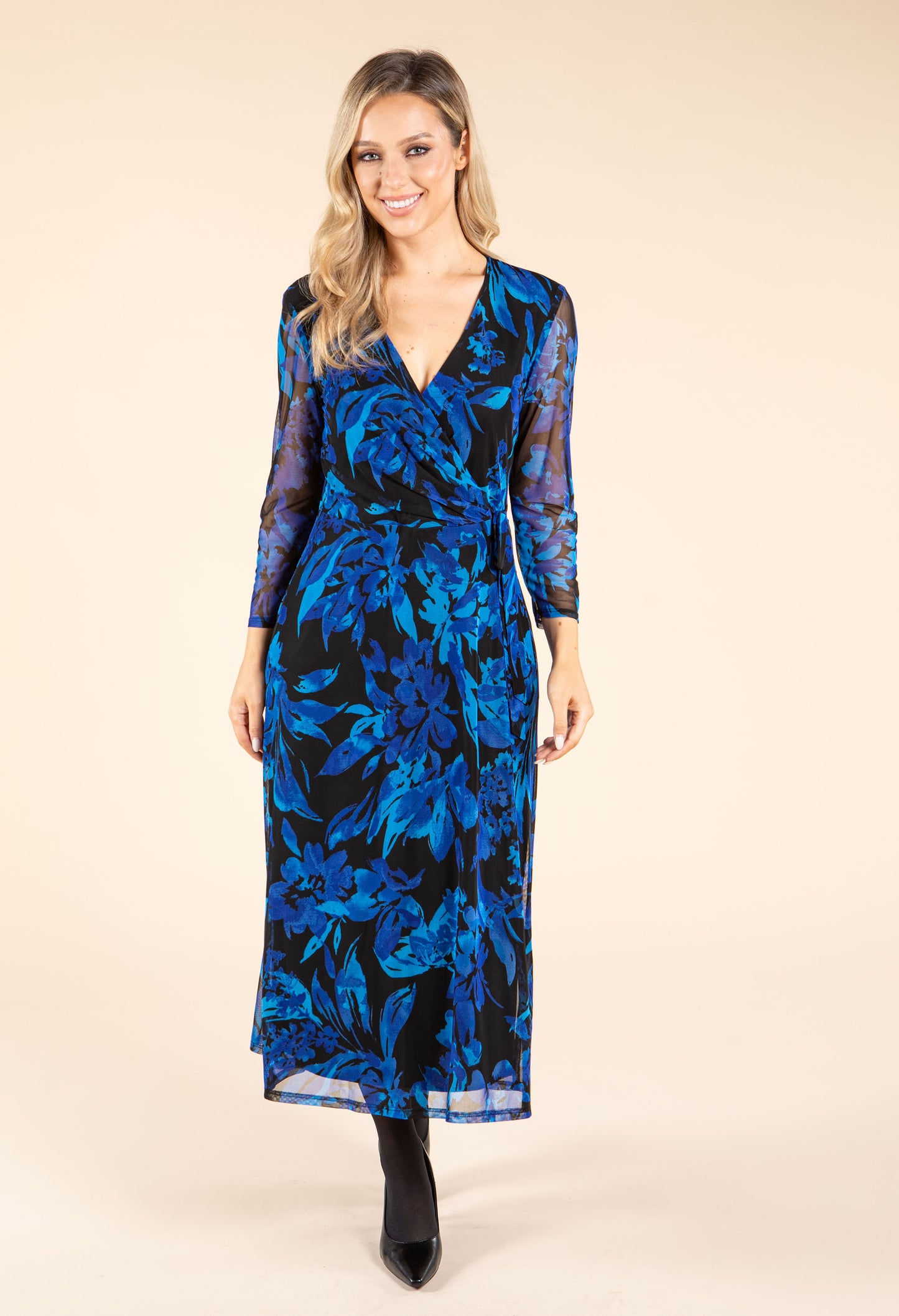 Woman wearing a blue floral dress on a beige background