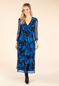 Woman wearing a blue floral dress on a beige background