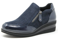 Blue slip-on shoe with a zipper on a white background