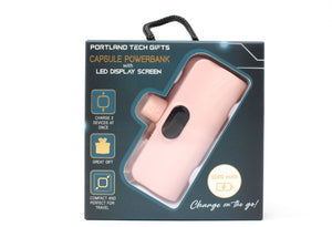 Pink power bank in packaging with text on a white background