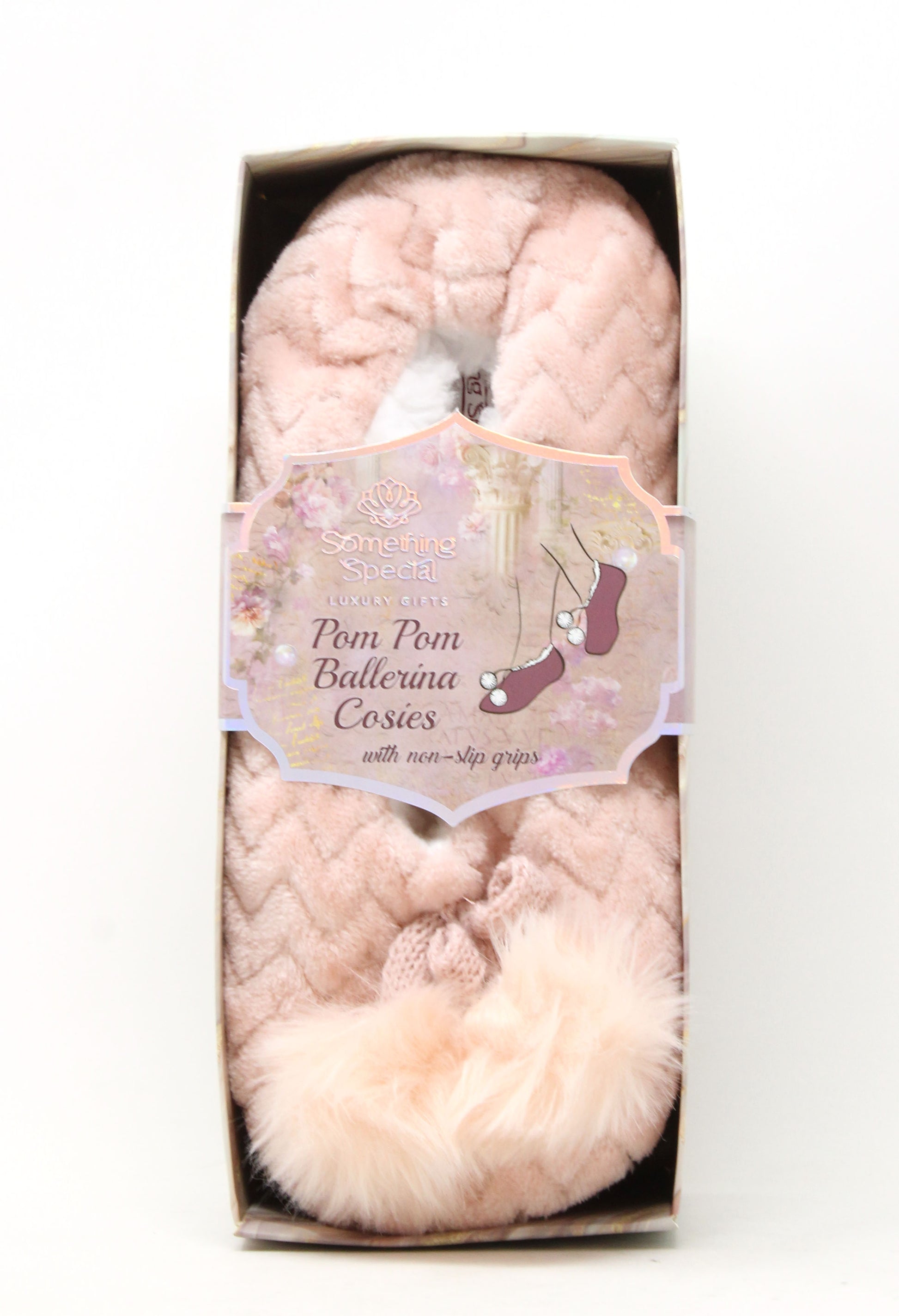 Pink pom-pom ballerina shoes in packaging with a decorative label on a white background