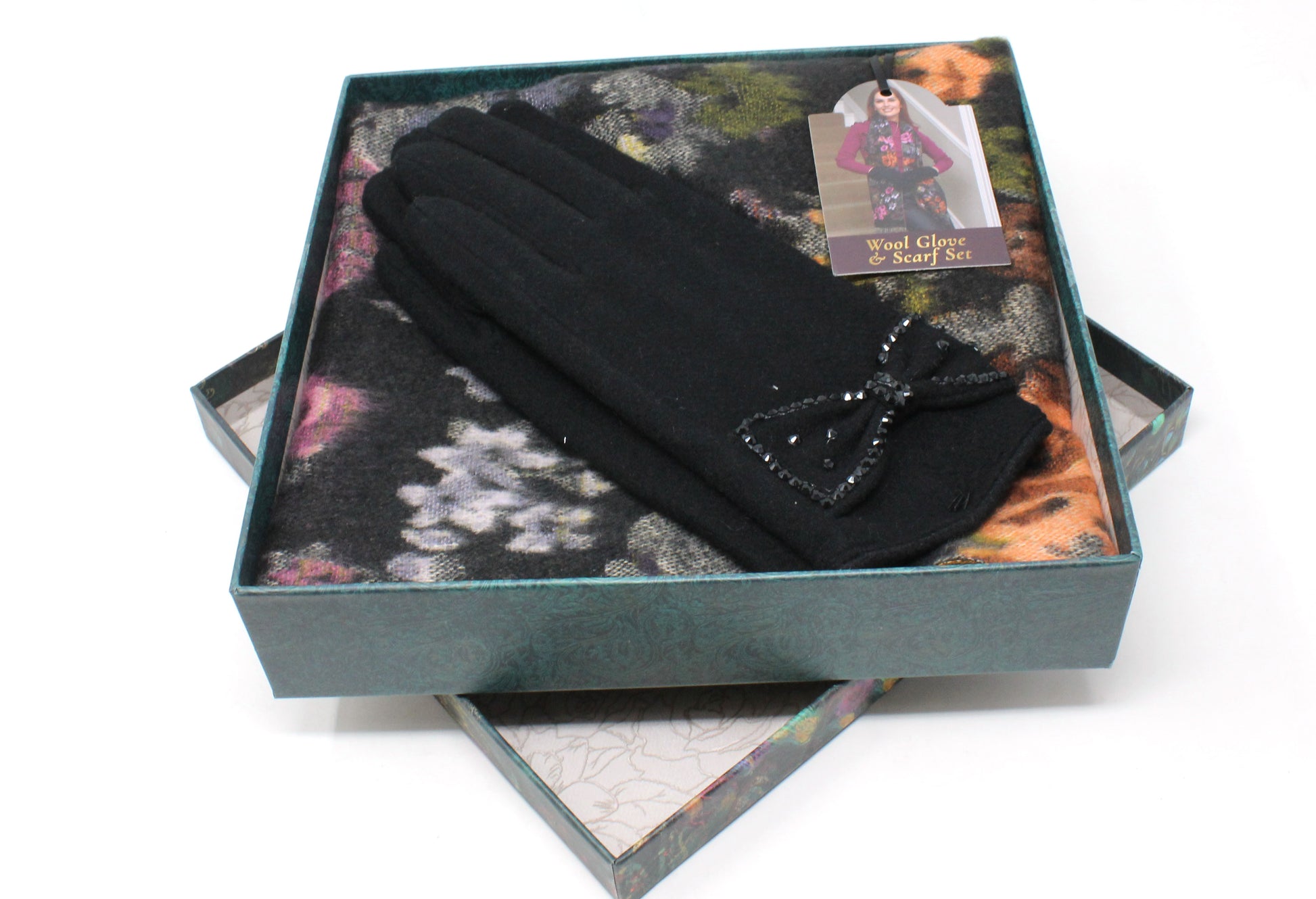 Black gloves with a bow in a decorative box on a white background