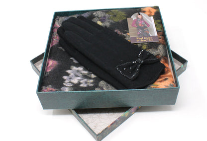 Black gloves with a bow in a decorative box on a white background
