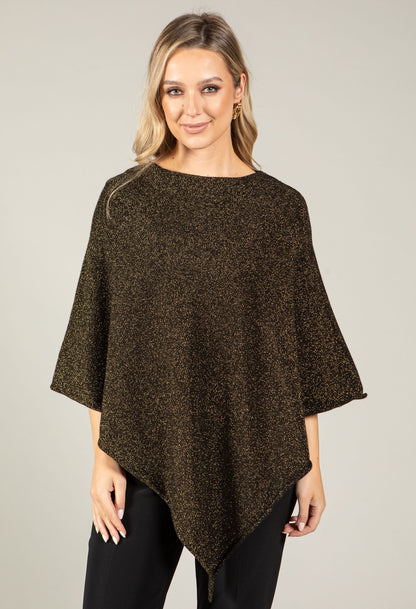Woman wearing a brown poncho against a plain background