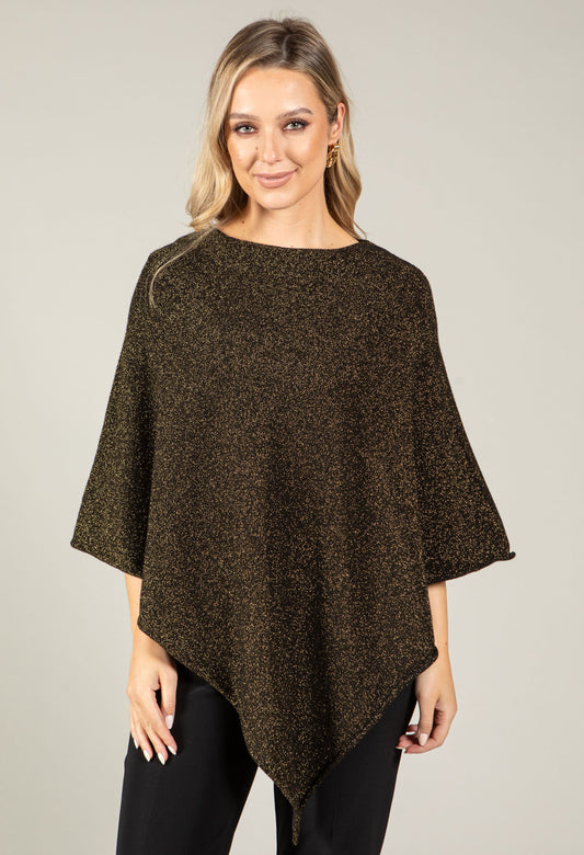 Woman wearing a brown poncho against a plain background
