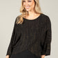 woman wearing an asymmetrical knit top with lurex
